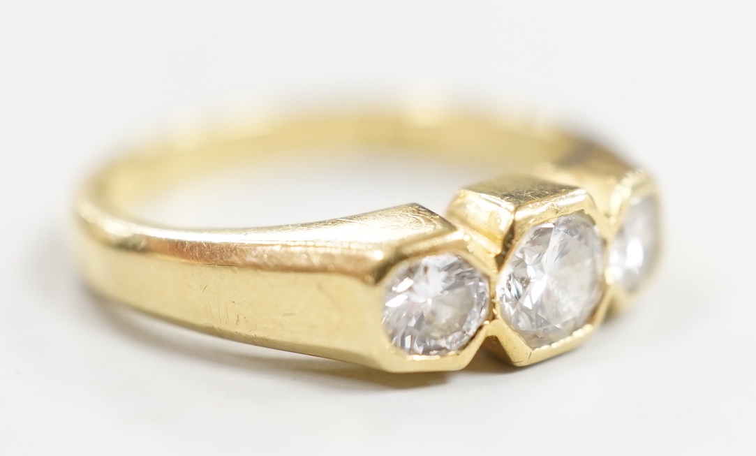 A modern 18ct gold and collet set three stone diamond ring, size M/N, gross weight 5 grams.